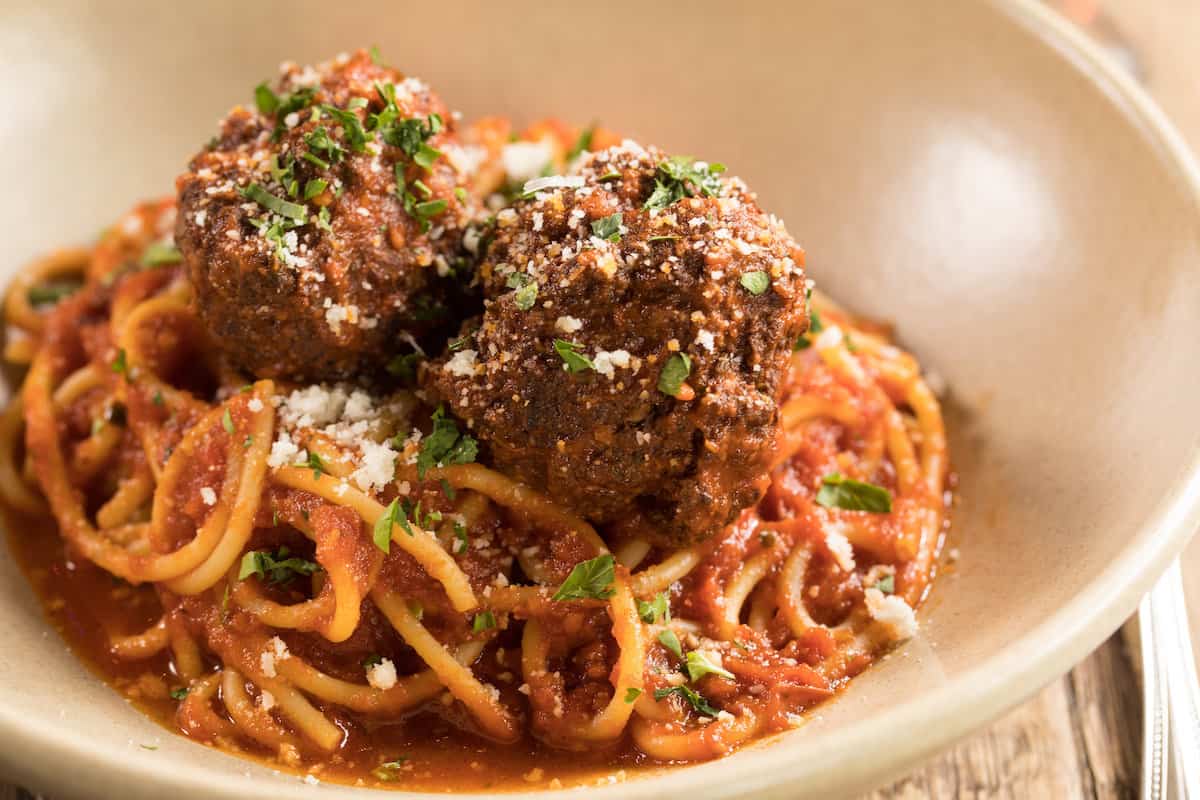 Red Rabbit Minneapolis signature dishes Oysters, Spicy Salami Pizza, Rigatoni with Meatballs, Cacio e Pepe, Focaccia with Goat Butter.